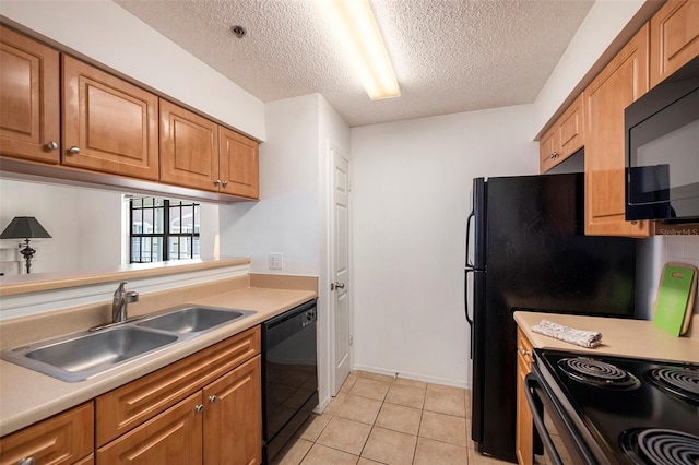 kitchen featuring sink, black appliances, a textured ceiling, and light tile patterned flooring