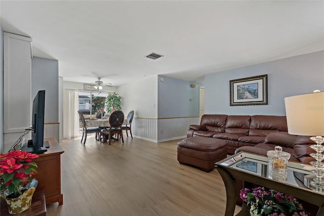 living room featuring ceiling fan and light wood-type flooring