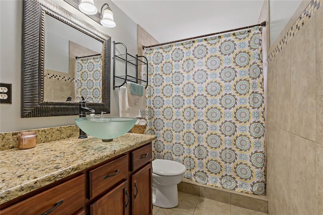 bathroom featuring vanity, tile patterned floors, and toilet