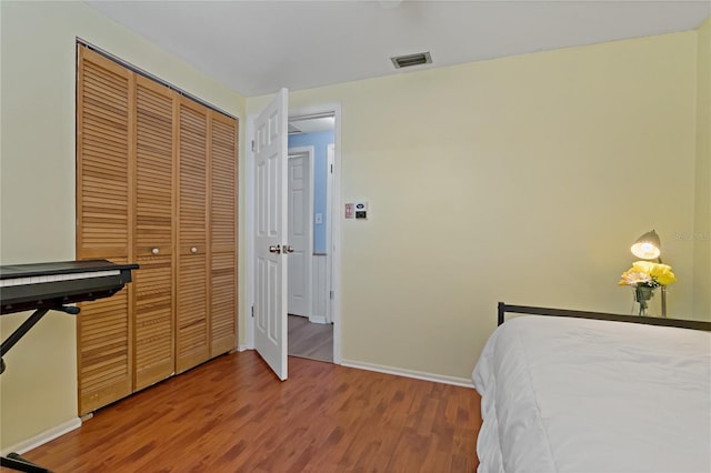 bedroom with hardwood / wood-style floors and a closet