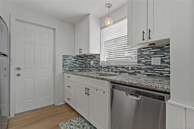 kitchen with white cabinetry, dishwasher, sink, hanging light fixtures, and light stone counters