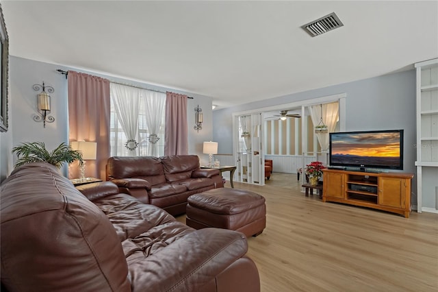 living room featuring ceiling fan and light wood-type flooring