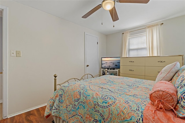 bedroom with ceiling fan and dark hardwood / wood-style flooring