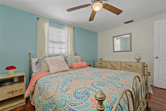 bedroom with dark hardwood / wood-style floors and ceiling fan