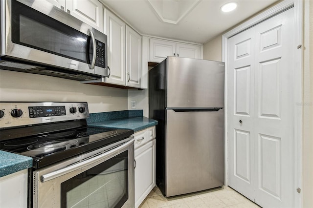 kitchen featuring white cabinetry and appliances with stainless steel finishes