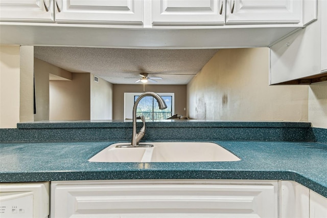 kitchen with white cabinetry, sink, a textured ceiling, and ceiling fan