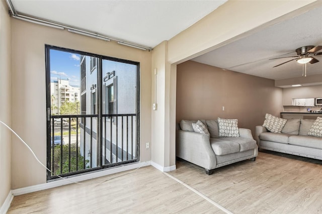 unfurnished living room featuring wood-type flooring and ceiling fan