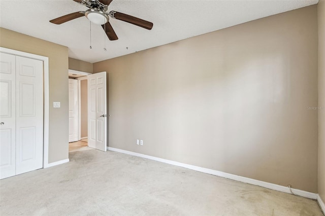 unfurnished bedroom with ceiling fan, a closet, and light carpet