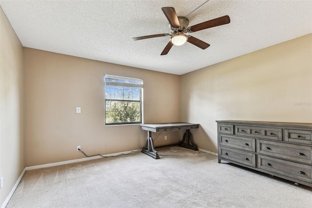 interior space with ceiling fan, light colored carpet, and a textured ceiling