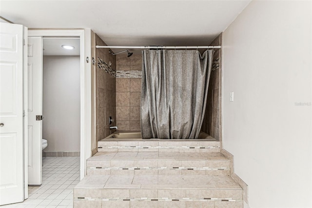 bathroom featuring a shower with curtain, tile patterned floors, and toilet