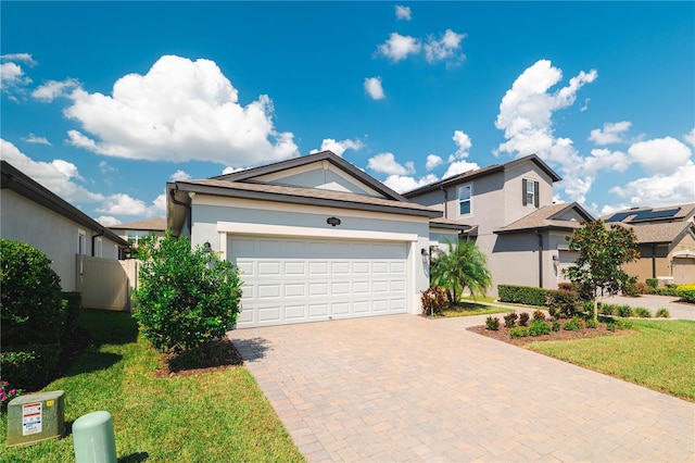 view of front of home with a garage and a front lawn