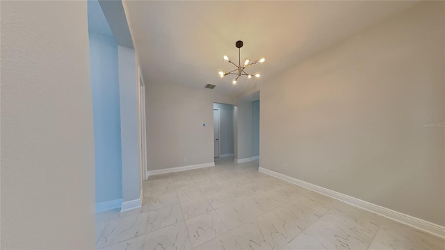 empty room featuring an inviting chandelier