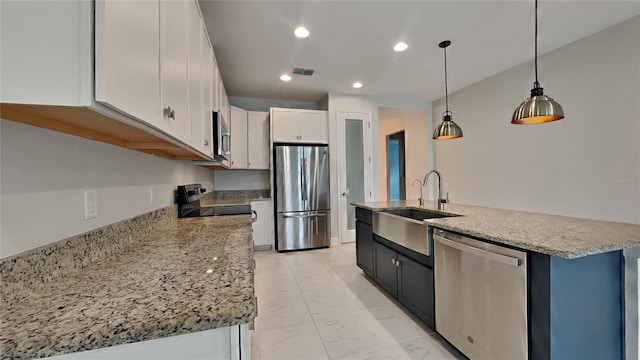 kitchen with sink, white cabinetry, light stone counters, hanging light fixtures, and appliances with stainless steel finishes