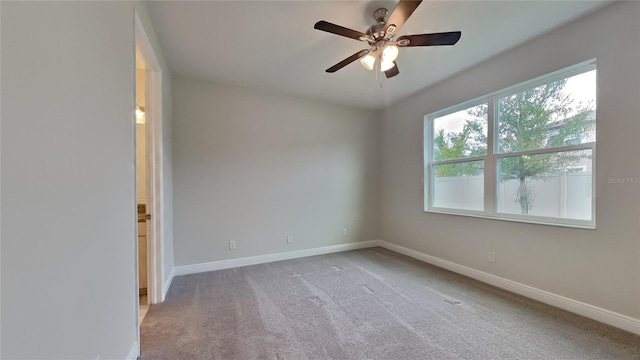 spare room with light carpet and ceiling fan