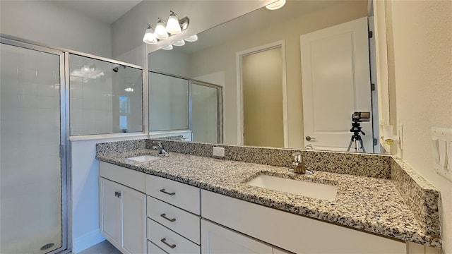 bathroom with vanity and a shower with shower door