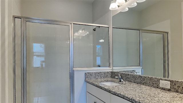 bathroom with vanity and a shower with shower door