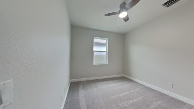 carpeted spare room featuring ceiling fan