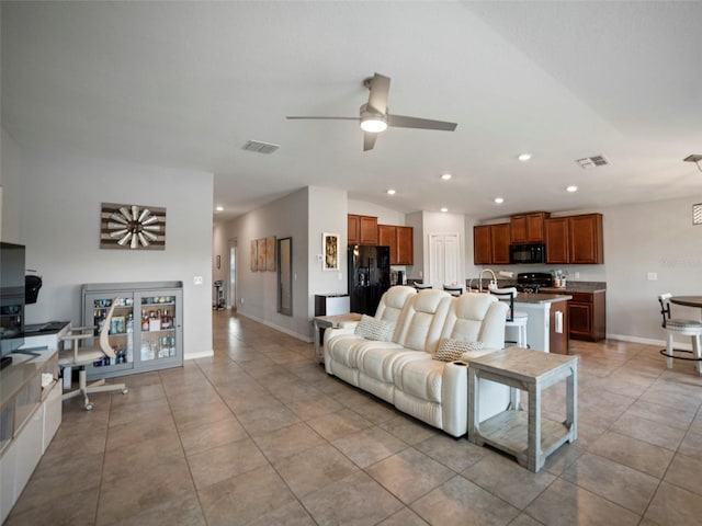 tiled living room with sink and ceiling fan