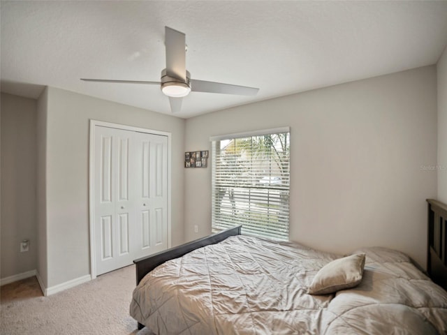 carpeted bedroom featuring a closet and ceiling fan