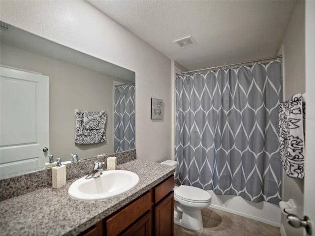 full bathroom featuring tile patterned floors, toilet, shower / tub combo, a textured ceiling, and vanity