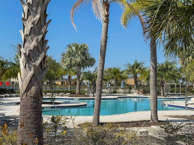 view of swimming pool featuring a hot tub