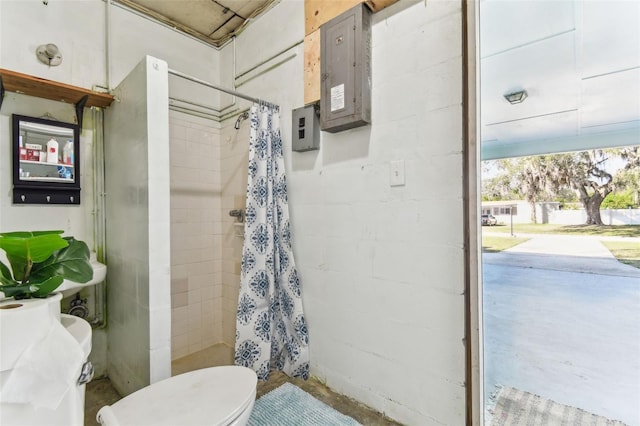 bathroom featuring walk in shower, toilet, and electric panel