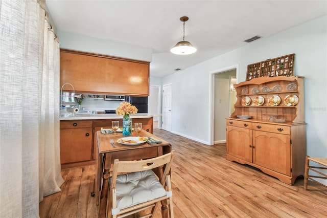 kitchen featuring pendant lighting and light hardwood / wood-style floors