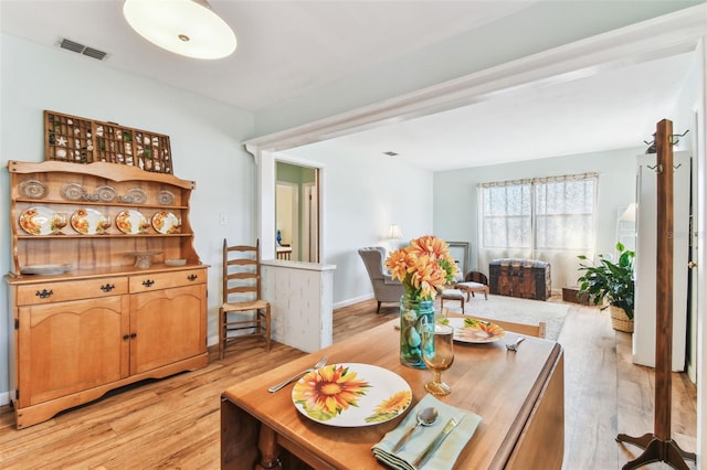 dining space with light hardwood / wood-style floors