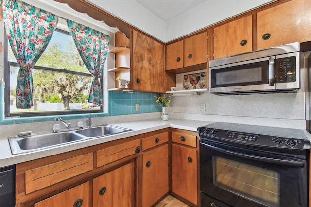 kitchen featuring tasteful backsplash, sink, and black appliances