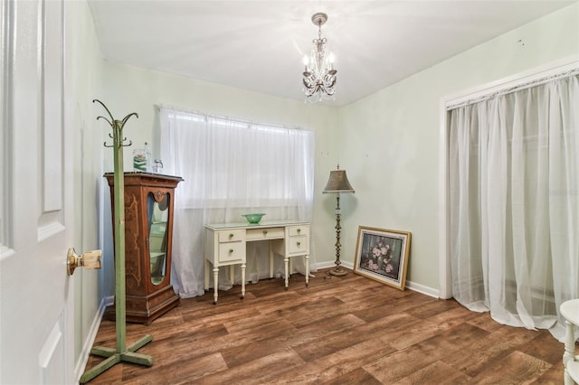 living area featuring dark wood-type flooring and a notable chandelier