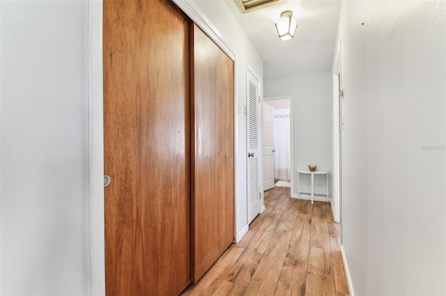 corridor with light wood-type flooring