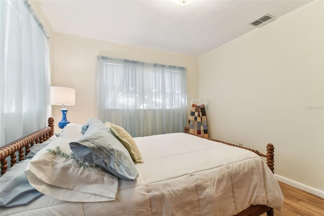 bedroom with hardwood / wood-style floors