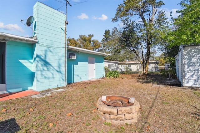 view of yard featuring a storage unit and a fire pit