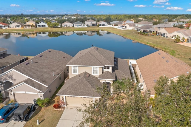 birds eye view of property with a water view and a residential view