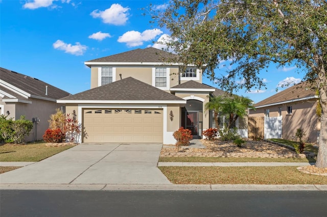 traditional home featuring a garage, a shingled roof, concrete driveway, and stucco siding