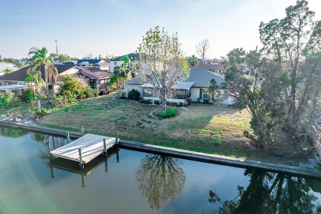 view of dock featuring a water view and a yard