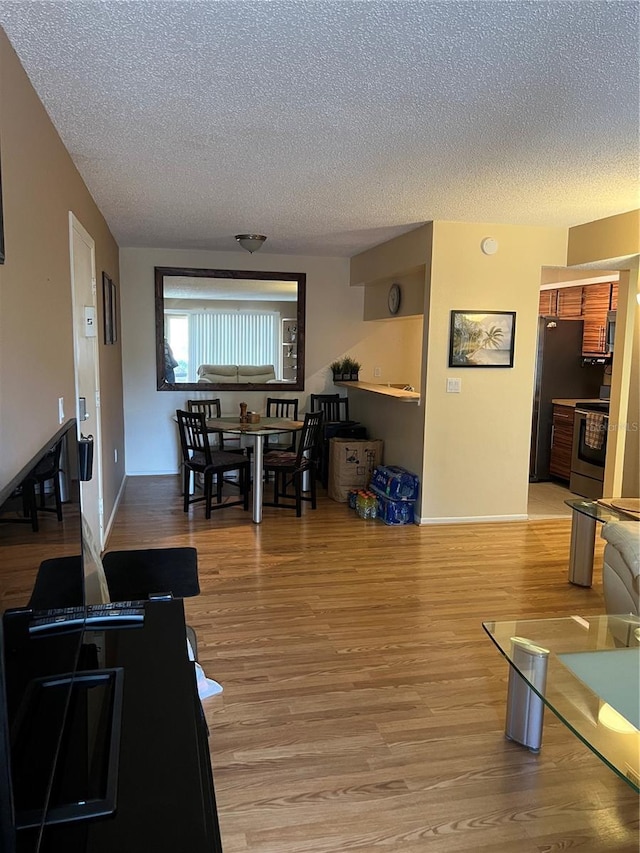 living room with hardwood / wood-style flooring and a textured ceiling