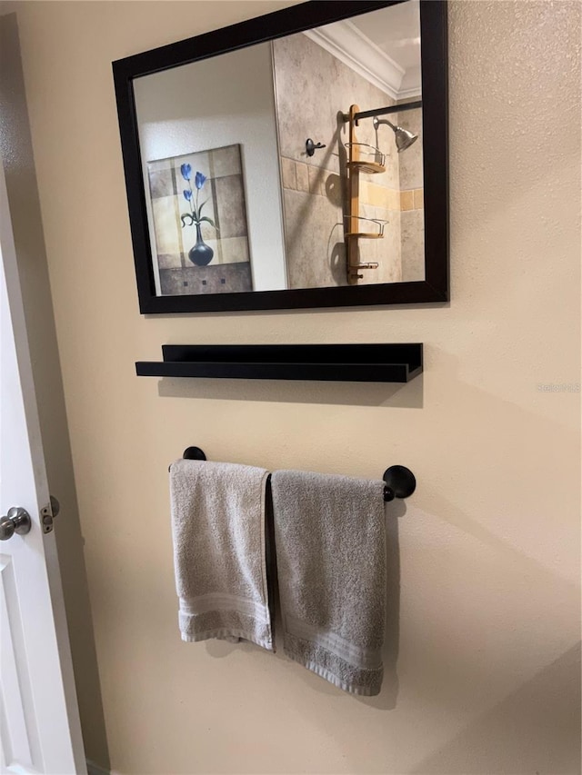 interior details with ornamental molding and a shower