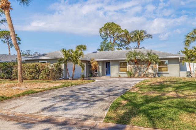 single story home with a garage and a front lawn