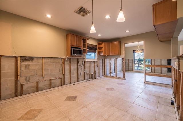 kitchen featuring light tile patterned flooring and decorative light fixtures