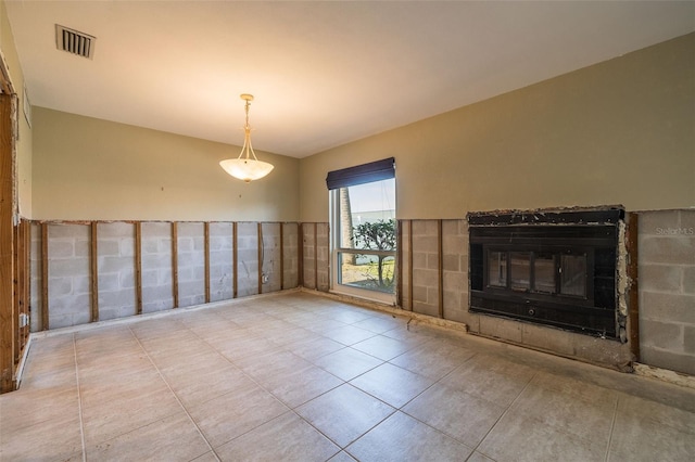 unfurnished living room featuring light tile patterned flooring