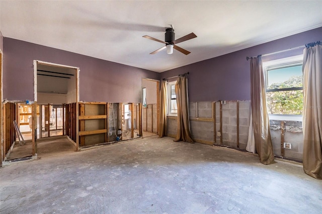 interior space with ceiling fan and concrete flooring