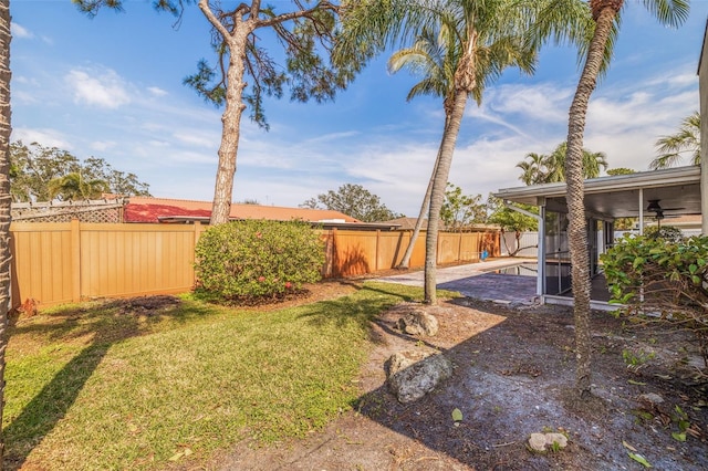 view of yard with ceiling fan and a patio area