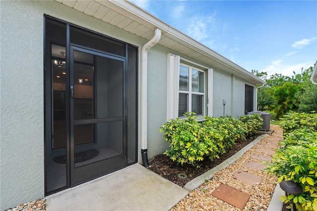 entrance to property featuring central AC