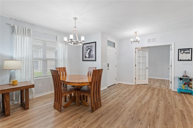 dining room with a chandelier and light hardwood / wood-style floors