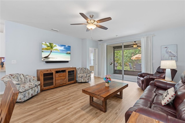 living room with ceiling fan and light hardwood / wood-style flooring