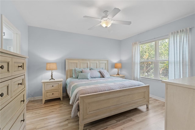 bedroom with ceiling fan and light hardwood / wood-style floors