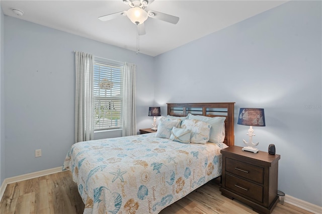 bedroom with light hardwood / wood-style floors and ceiling fan