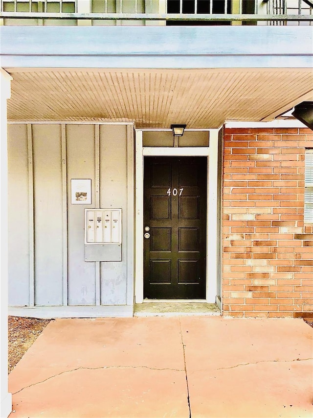 entrance to property featuring brick siding