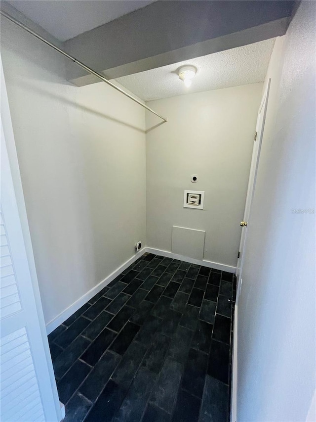 laundry room featuring washer hookup, hookup for an electric dryer, a textured ceiling, and baseboards